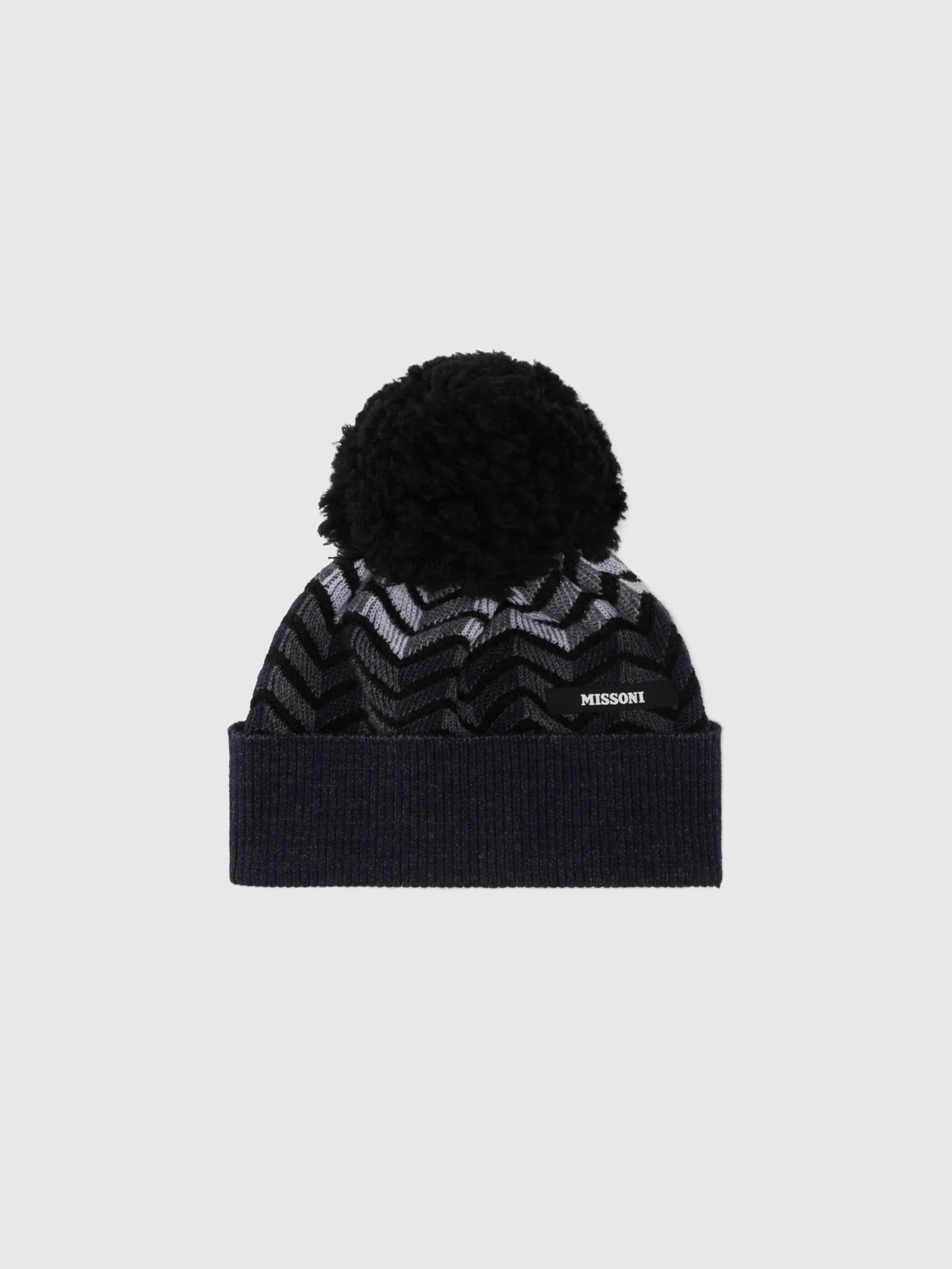 Cappello in lana vergine zig zag con logo e pon pon