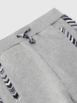 Joggers in cotone con inserti zig zag