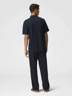 Polo in piquet di cotone tinta unita con ricamo zig zag e dettaglio a contrasto